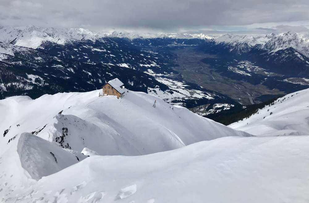 Kellerjoch Skitour: Auf dem Weg zur Kellerjochkapelle der Blick zurück auf die Kellerjochhütte, rechts das Karwendelgebirge