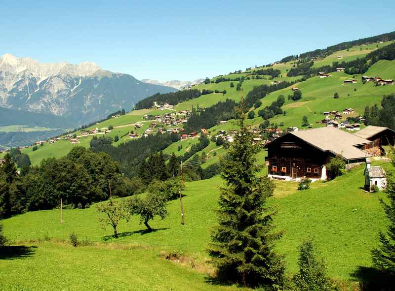 Der idyllische Ort Kolsassberg in den Tuxer Alpen, unten das Inntal, am Horizont das wunderschöne Karwendelgebirge