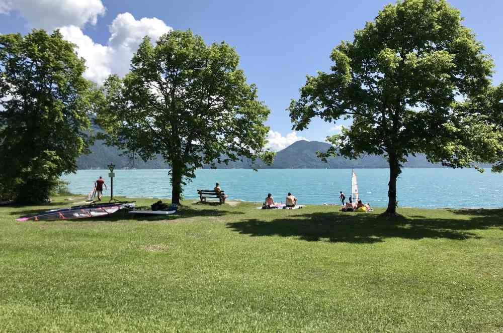 Die große Liegewiese am Eingang vom Ort Walchensee - samt Surfschule und Parkplatz